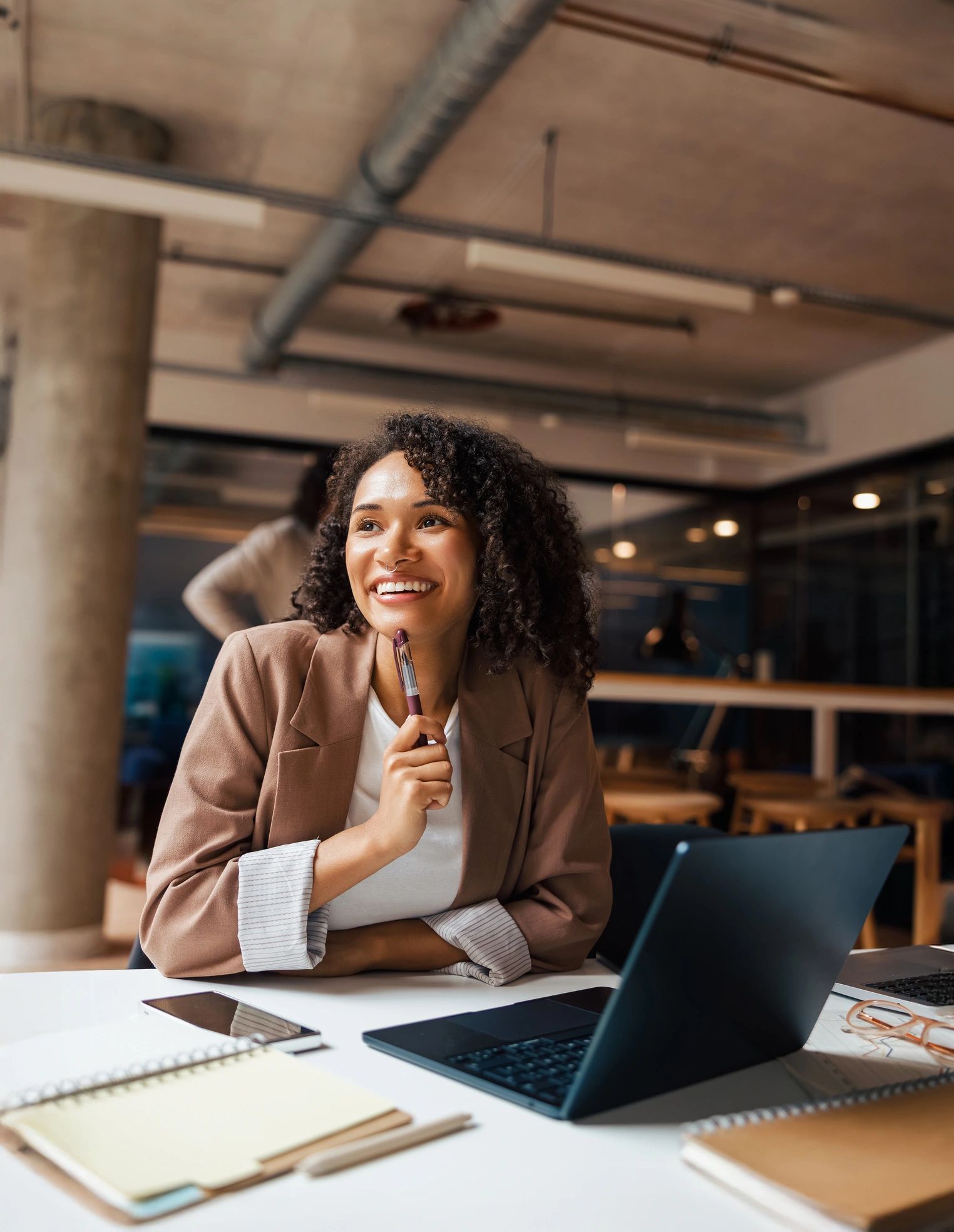 Professional woman working thoughtfully in a modern office